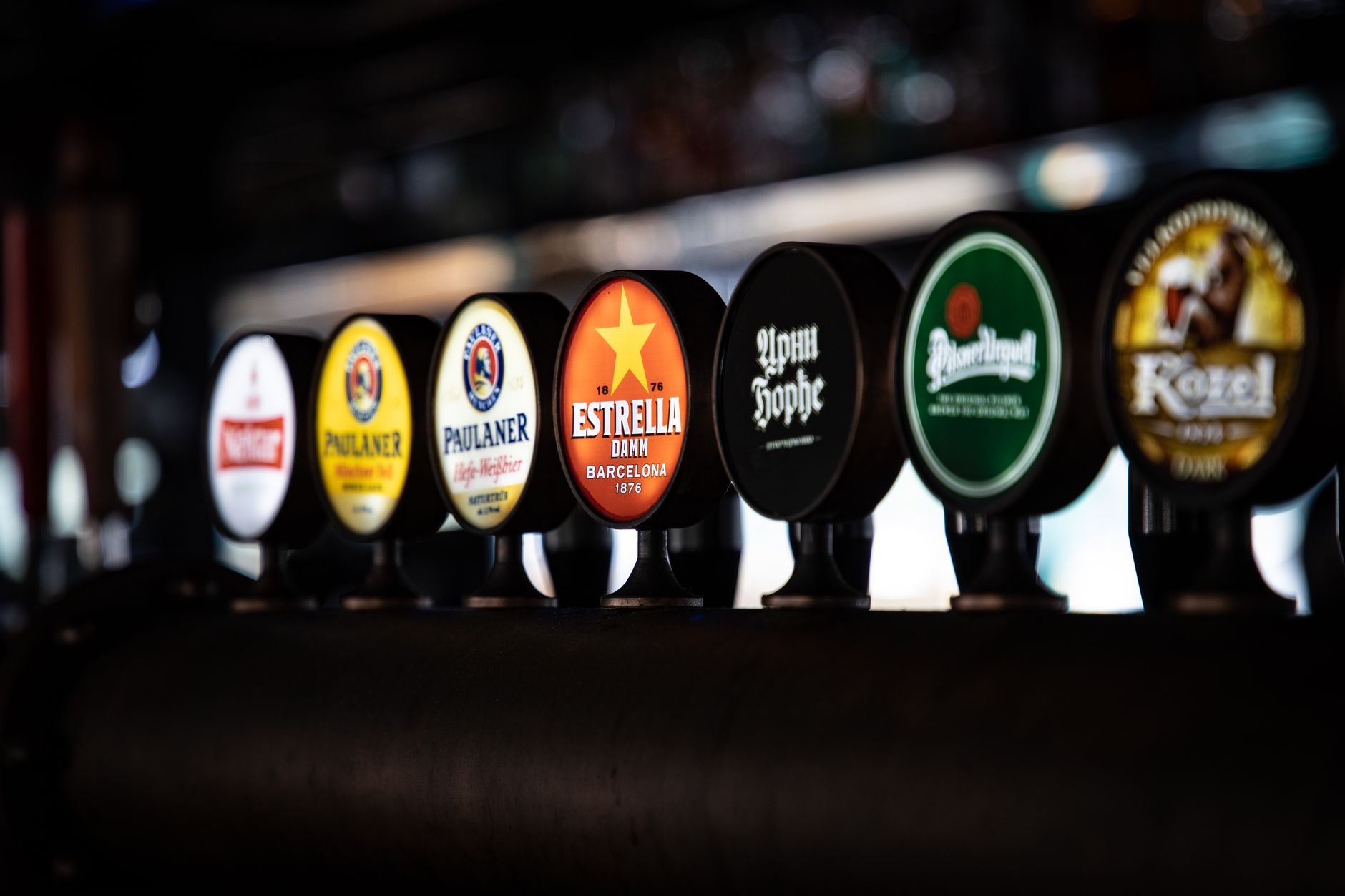 row of beer labels in a bar